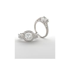 two white gold engagement rings with diamonds on the sides and an oval shaped diamond in the middle