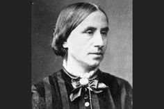 an old black and white photo of a man with long hair wearing a bow tie