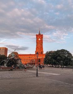 an orange building with a clock tower in the middle