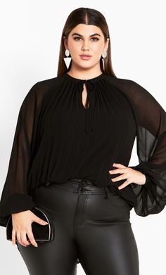 Drape your curves with the gorgeously chic Crysta Top. Made with your curves in mind, this sophisticated top offers a relaxed fit, notched V-neckline and a pleated design to finish a gorgeous structure. Key Features Include: - Pleated Design - Notched V-neckline - Full length sleeves with elastic cuffs - Neck tie detail - Relaxed fit - Lined - Pullover style Wear with a fitted midi skirt and ankle heel boots. | Avenue Women's Top Crysta In Black - Size 12 By City Chic Ankle Heel Boots, Fitted Midi Skirt, Plus Size Top, Chic Woman, New Tops, Heel Boots, City Chic, Perfect Outfit, Pullover Styling