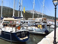 several sailboats are docked in the water