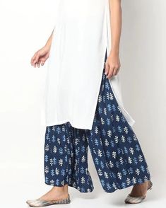 Indigo Handblock Printed Cotton Palazzo Pants | Floral Print Trouser Pants | Large Size Women's Palazzo Embrace the charm of our Cotton Indigo Palazzo pants, featuring intricate handblock printing and a comfortable drawstring waist. These palazzo pants are not only stylish but also designed with consideration for the unique characteristics of traditional techniques. Key Features: Handblock Printing: The characteristic imperfections associated with handblock printing may be observed, adding a dis Spring Sets With Side Slits, Summer Cotton Bottoms With Side Slits, White Rayon Wide-leg Pants, White Wide-leg Rayon Pants, White Cotton Wide Leg Sets, Loosely Fitted Cotton Culottes, White Cotton Long Skirt, Cotton Palazzo Pants, Floral Dress Design