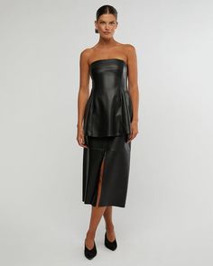 The Black Vegan Leather Midi Made Skirt by We Wore What is a timeless and versatile piece that is perfect for any occasion. It is made from high-quality black leather that is both soft and durable. The skirt features a flattering A-line silhouette and a mid-length cut that is both stylish and comfortable. It is also available in a variety of sizes to fit all body types. <p data-sourcepos="5:1-5:278" data-mce-fragme... Black Leather Skirt For Evening, Sleek Leather Party Skirt, Black Leather Skirt For Party, Black Leather Knee-length Skirt, Date Night Fitted Leather Skirt, Elegant Evening Faux Leather Skirt, Leather Midi Skirt For Evening, Evening Leather Midi Skirt, Chic Black Leather Skirt