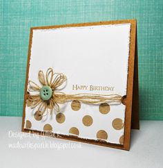 a happy birthday card with a button and polka dot design on it, sitting on a table