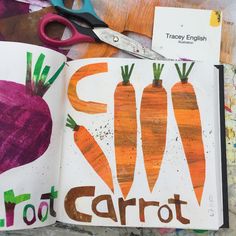 an open book with carrots drawn on it next to scissors and other art supplies