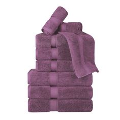 a stack of purple towels folded on top of each other in front of a white background