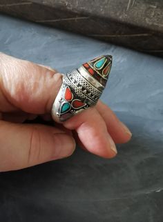 I bought this ring on my last visit to Marrakech, about 12 years ago. To me, it looks like an Afghan ring with Tibetan or Mongolian influence. A very well made vintage ring. The craftsmanship is superb, and high-quality silver was used with nice turquoise and coral inlay. Unfortunately, the ring is too small for me... Additional purchases travel free. More delights on https://www.etsy.com/au/shop/Seraii Traditional Turquoise Rings Collectible, Handmade Antique Turquoise Ring Collectible, Antique Handmade Turquoise Collectible Ring, Vintage Turquoise Inlay Ring For Gift, Vintage Multi-stone Turquoise Ring Gift, Handmade Vintage Turquoise Open Ring, Traditional Gemstone Rings For Collectors, Travel Free, Turquoise And Coral