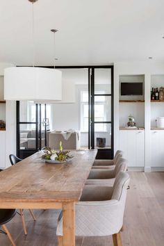 a wooden table sitting in the middle of a kitchen