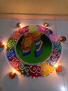 a colorful rangdi with candles on the floor