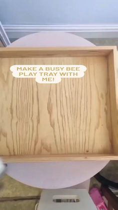 a wooden tray with words on it sitting on top of a white toilet seat in a bathroom