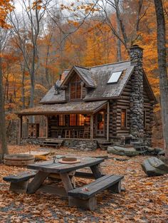 a log cabin with picnic table and fire pit