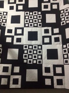 a black and white quilt with squares on it