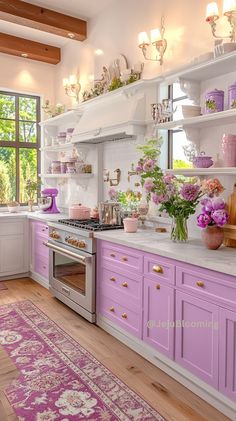 a kitchen with purple cabinets and pink rug