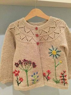 a knitted sweater with flowers on it