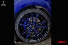 the front wheel of a blue sports car