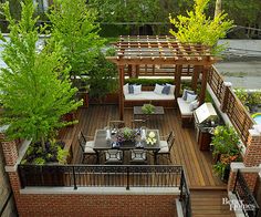 an outdoor deck with seating and tables surrounded by trees