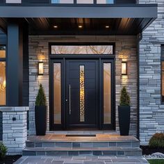 the front entrance to a modern home with stone steps and planters on either side