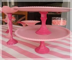 there is a pink cake stand on the table