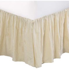 a bed skirt with pleated edges on the top and bottom, in beige stripes