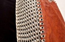 a woman's purse with metal rivets on it