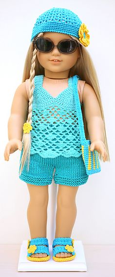 a doll wearing sunglasses and a blue knitted outfit