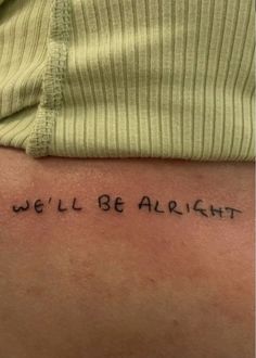 a person with a tattoo that says, we'll be alright on their back