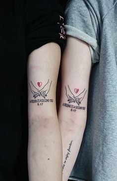 two people with matching tattoos on their arms, one has a heart and the other has an arrow