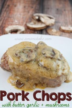 pork chops with butter garlic mushrooms on a white plate