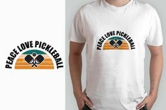 a man wearing a white t - shirt with the words peace love pickleball on it