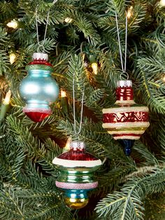 three ornaments hanging from a christmas tree