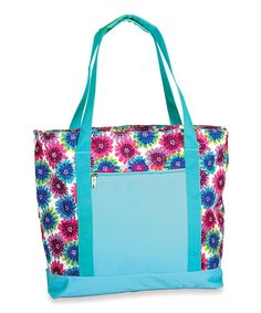 a blue and pink flowered tote bag with zippers on the front, two handles