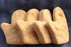 several pieces of bread are arranged in the shape of hands on a blue cloth background