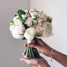 a person holding a bouquet of flowers in their hand