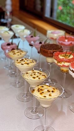 many desserts are lined up on the table