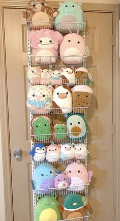 a shelf filled with lots of stuffed animals on top of it next to a door