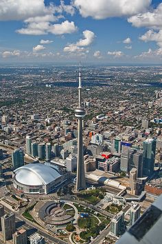 an aerial view of a city with tall buildings and a large dome in the center