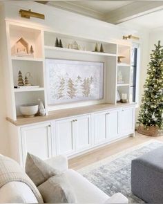 a living room filled with furniture and a christmas tree