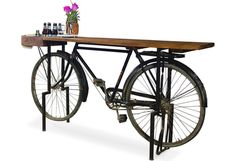 an old fashioned bicycle with flowers and bottles on it