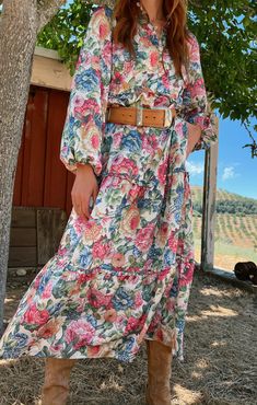 Feel like a dream in the Loretta Maxi. Lightweight silky fabric, with a vintage floral print throughout, shapes this beautiful dress that falls from a buttoned high neckline into a relaxed tiered bodice and billowy volume sleeve. We love this maxi styled with booties, a belt and a rancher hat for the ultimate floral cowgirl aesthetic. Cowgirl Boots With Dress, California Cowgirl, Boots With Dress, Pastel Floral Dress, Maternity Dress Outfits, Boho Maternity, Brunch Dress, Rancher Hat, Cowgirl Aesthetic