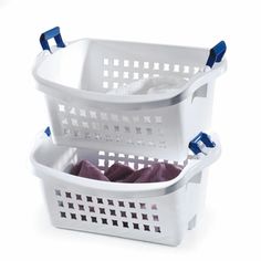 two white laundry baskets with blue handles