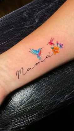 a small wrist tattoo with the word mama written on it