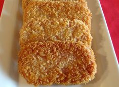 three pieces of fried food on a white plate