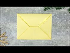 an origami envelope and starfish on a concrete background with text overlay