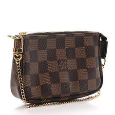 This is an authentic LOUIS VUITTON Damier Ebene Mini Pochette Accessories. This small pochette is crafted of classic brown Louis Vuitton signature Damier canvas. The pochette features a polished gold chain that can form a wristlet and a top zipper that opens to a red fabric interior. Mini Pochette Accessories, Pochette Accessories, Classic Brown, Louis Vuitton Damier Ebene, Damier Ebene, Red Fabric, Authentic Louis Vuitton, Louis Vuitton Damier, Gold Chain