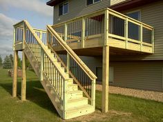 a house with a deck and stairs in front of it