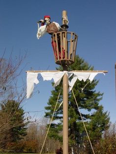 a pirate's ship on top of a pole in the middle of a park