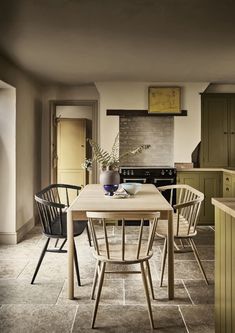 a kitchen with a table and chairs in it