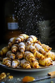 powdered sugar sprinkled pastries on a plate