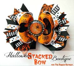 an orange and black hair bow with mickey mouse on it