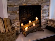 candles are lit in front of a fireplace